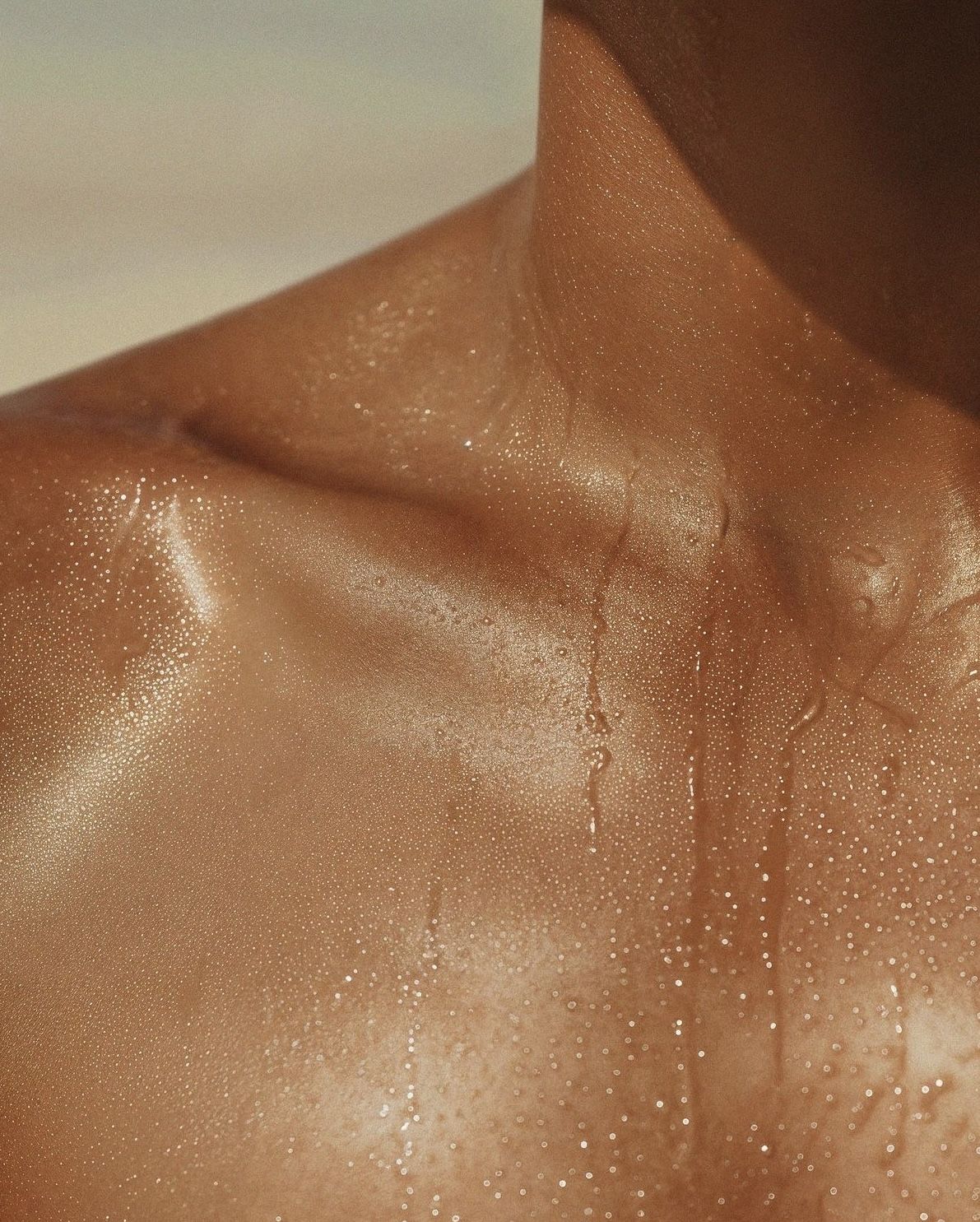 Glowing, dewy skin with water droplets — Nudea's tallow-based skincare effect in natural light
