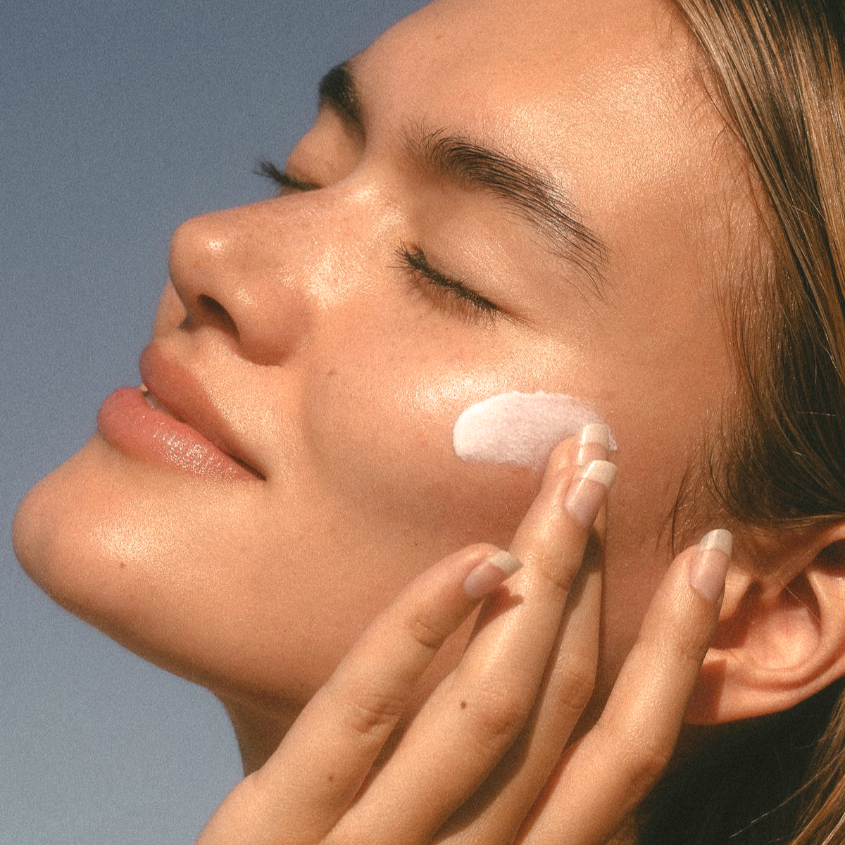 A woman enjoying the sun with Nudea Tallow Balm on her skin — clean beauty skincare from Australia, giving a radiant, natural glow.